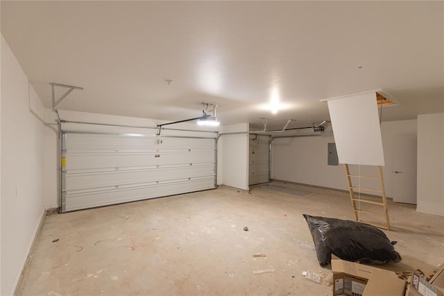 garage featuring electric panel, a garage door opener, and baseboards