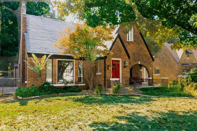 tudor home with a front yard