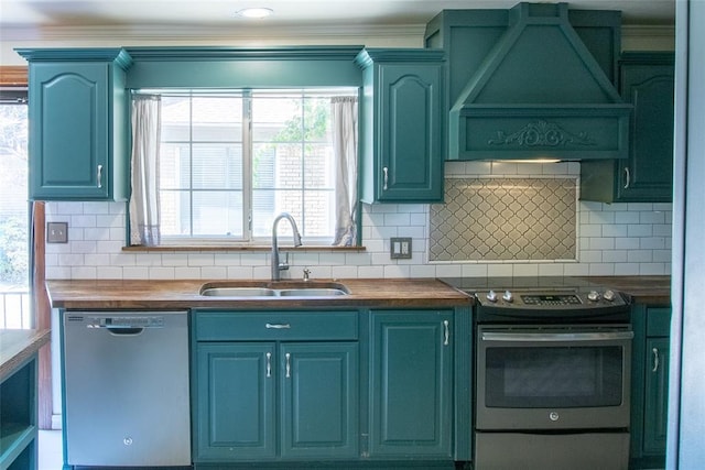 kitchen with plenty of natural light, sink, custom range hood, and appliances with stainless steel finishes