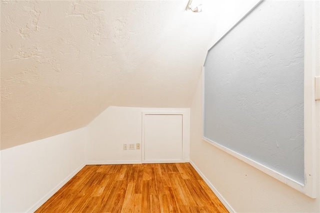 bonus room featuring hardwood / wood-style floors and lofted ceiling