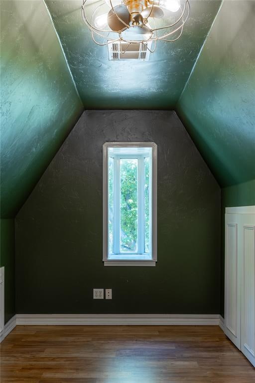 bonus room with vaulted ceiling and hardwood / wood-style flooring