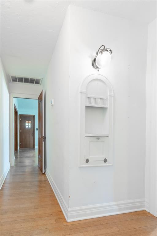 corridor with light wood-type flooring