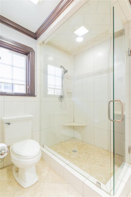 bathroom with toilet, tile patterned floors, a shower with shower door, and crown molding