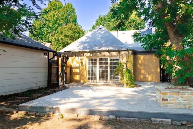 back of house featuring a wooden deck