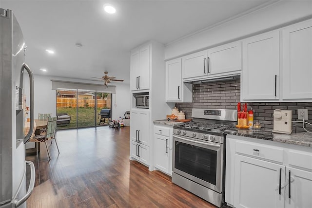 kitchen with white cabinetry, stainless steel range with gas cooktop, and white refrigerator with ice dispenser