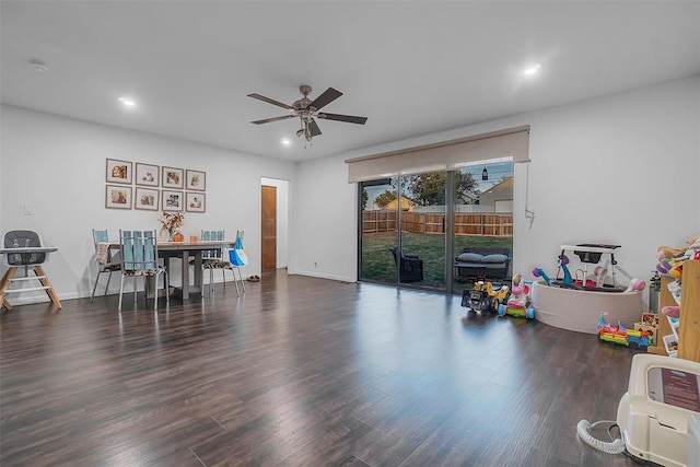 rec room with dark hardwood / wood-style flooring and ceiling fan