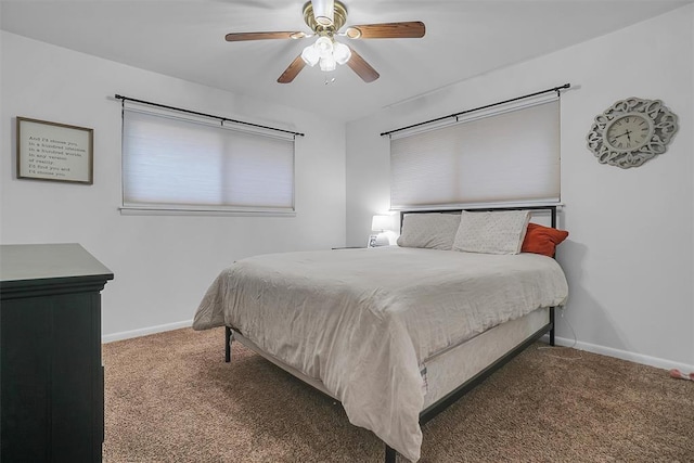 bedroom with ceiling fan and dark colored carpet