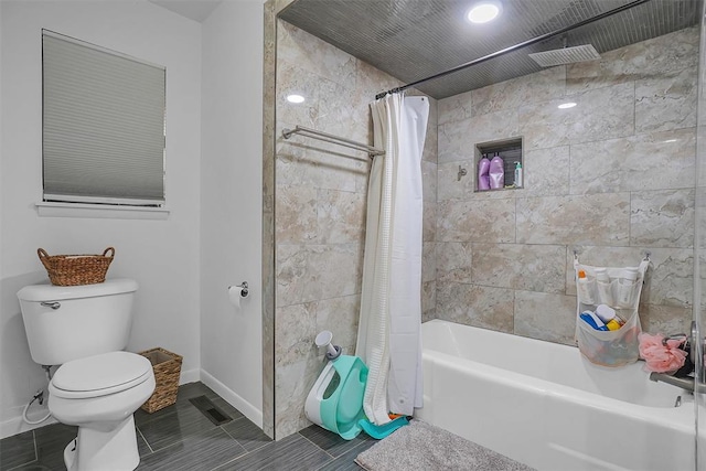 bathroom with shower / tub combo and toilet