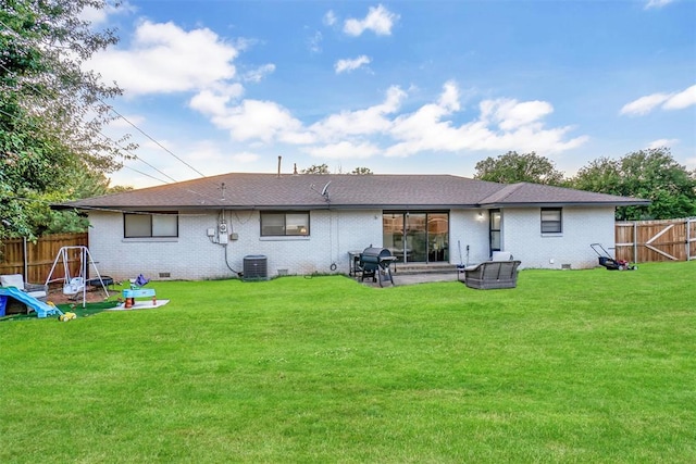 back of house featuring a lawn, central AC, and a patio