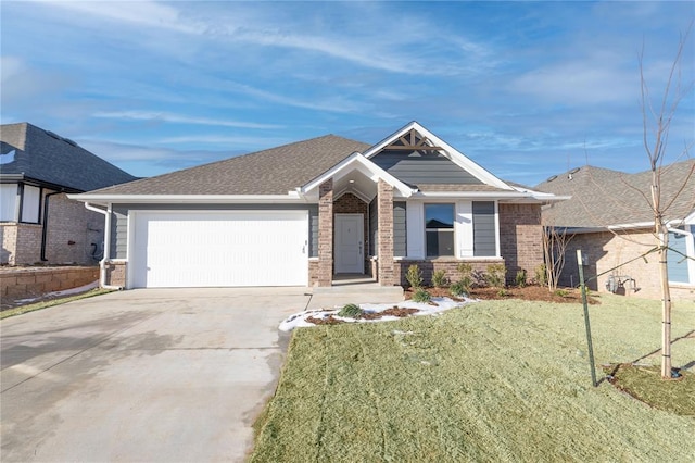 view of front of home with a garage, a front yard, concrete driveway, and brick siding