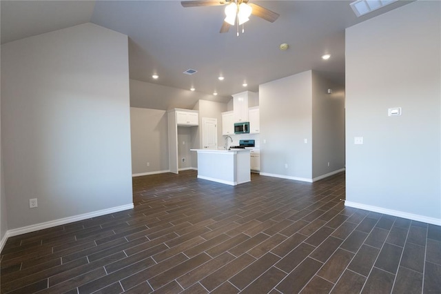 unfurnished living room featuring ceiling fan, vaulted ceiling, visible vents, and baseboards