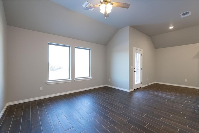 bonus room with vaulted ceiling, visible vents, and dark wood finished floors