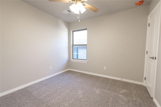 unfurnished room with carpet, visible vents, and baseboards