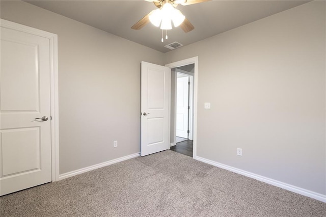 unfurnished bedroom featuring a ceiling fan, carpet, visible vents, and baseboards