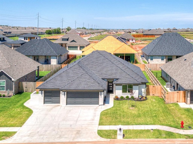 view of front facade featuring a front yard and a garage