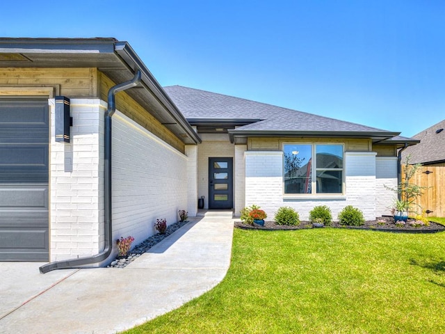 entrance to property featuring a lawn