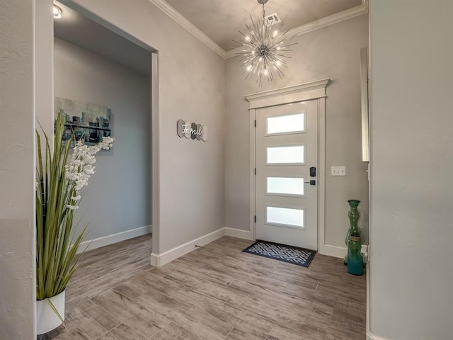 entryway with light wood-type flooring, ornamental molding, and an inviting chandelier