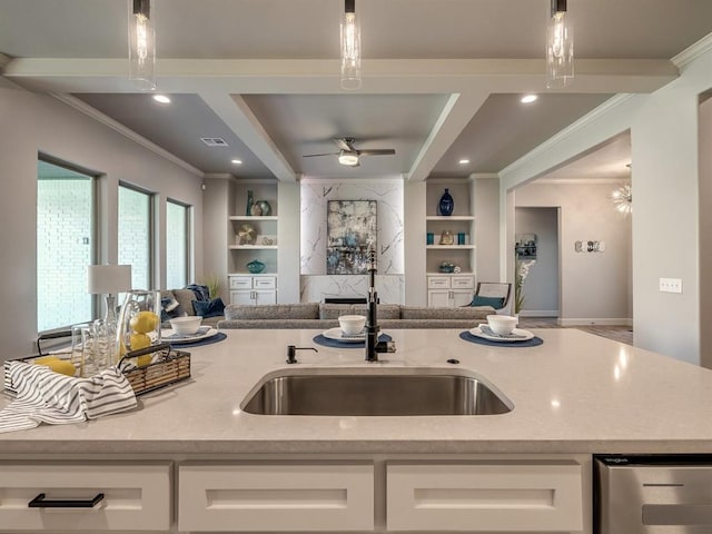 kitchen featuring pendant lighting, white cabinets, and light stone counters