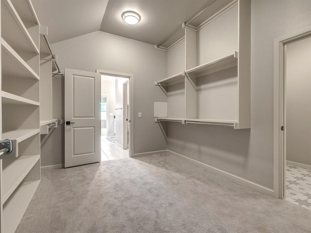 spacious closet featuring light carpet and lofted ceiling