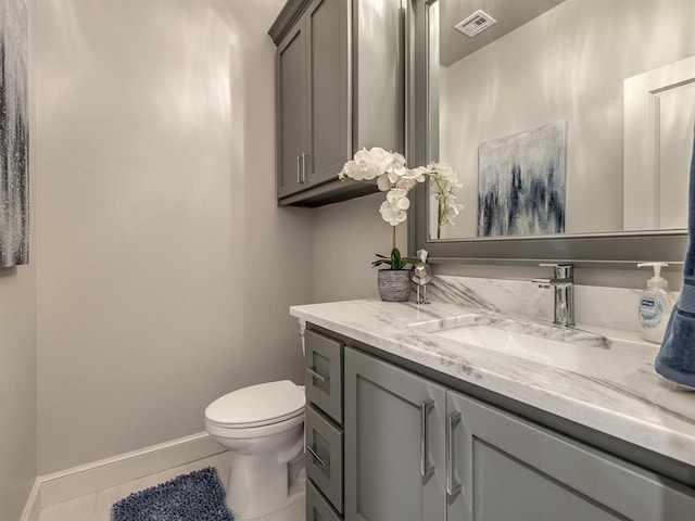 bathroom featuring tile patterned flooring, vanity, and toilet