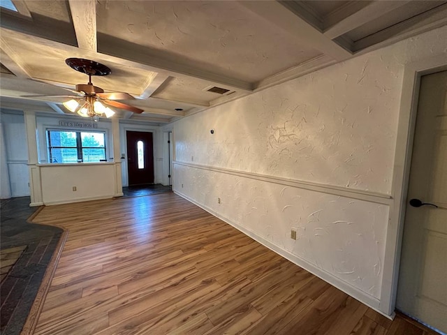 foyer with hardwood / wood-style floors, ceiling fan, and beam ceiling