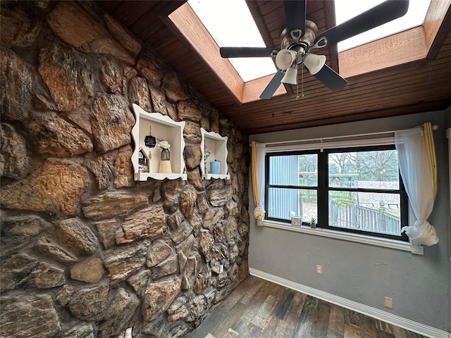 interior space with ceiling fan, dark hardwood / wood-style flooring, wooden ceiling, and lofted ceiling with skylight