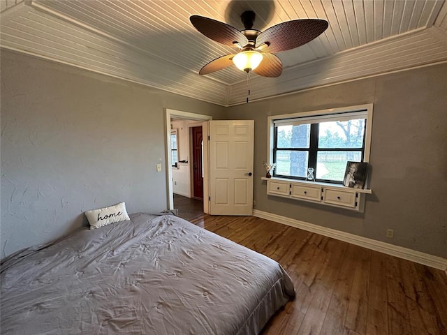 unfurnished bedroom with wood ceiling, ceiling fan, crown molding, and wood-type flooring