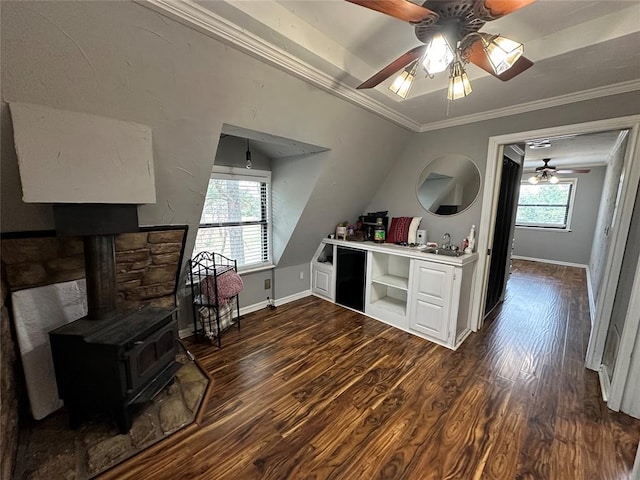 kitchen featuring white cabinetry, dark hardwood / wood-style flooring, a wood stove, and ornamental molding