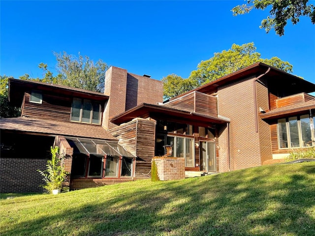 rear view of property featuring a yard