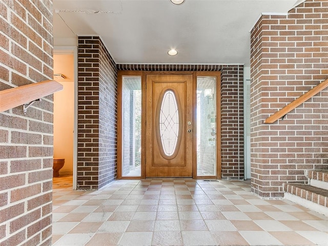 entryway with brick wall