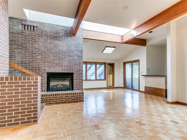 unfurnished living room with a fireplace, lofted ceiling with beams, light parquet floors, and brick wall