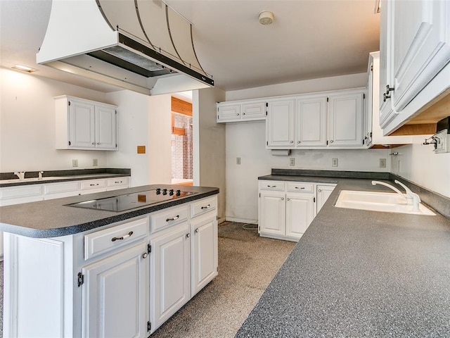 kitchen with a center island, white cabinets, black electric stovetop, sink, and range hood