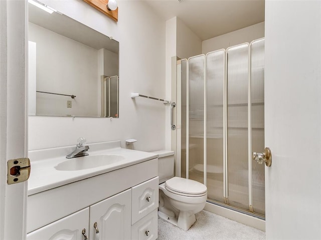 bathroom with an enclosed shower, vanity, and toilet