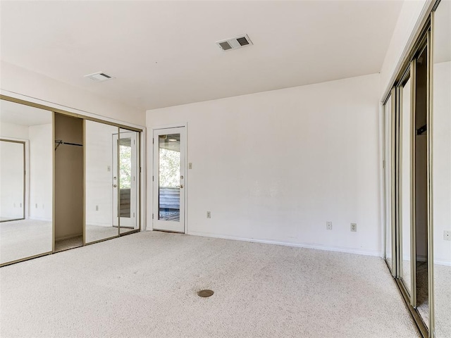 unfurnished bedroom featuring light colored carpet