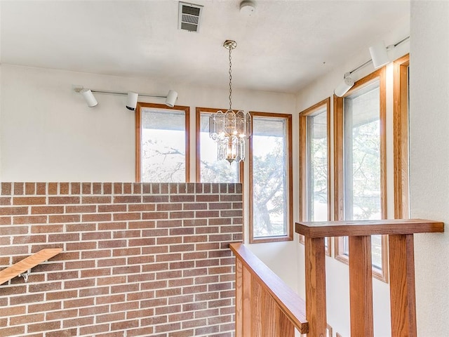 interior space with a healthy amount of sunlight and a notable chandelier