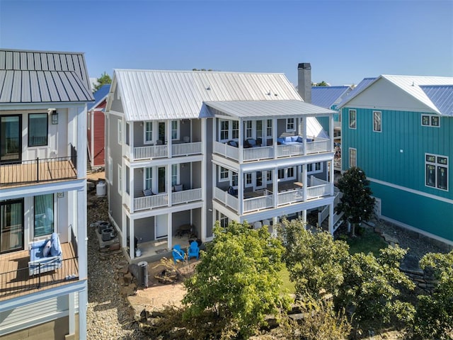 back of house featuring a balcony