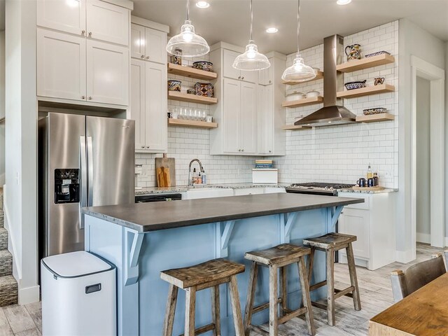 kitchen with stainless steel fridge with ice dispenser, decorative backsplash, wall chimney exhaust hood, and white cabinetry