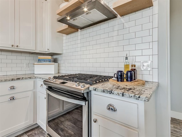 kitchen featuring gas stove, white cabinetry, wall chimney exhaust hood, and hardwood / wood-style flooring