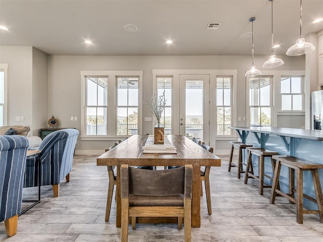 dining space featuring light hardwood / wood-style flooring and a healthy amount of sunlight