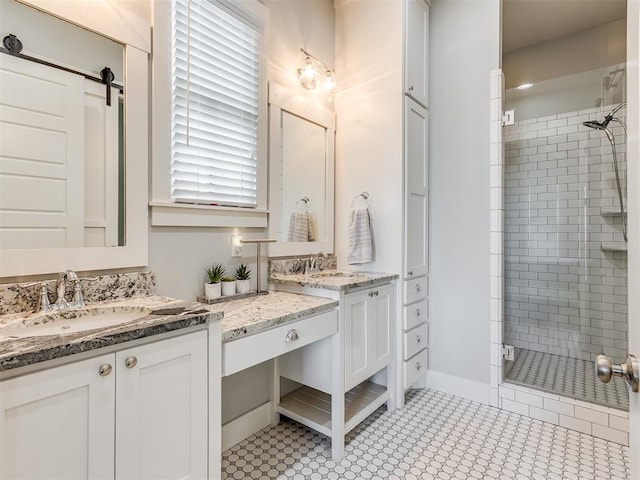 bathroom featuring tile patterned flooring, vanity, and an enclosed shower