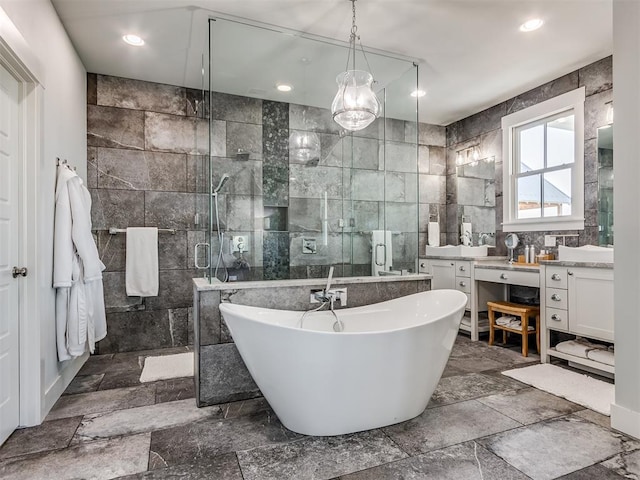 bathroom featuring vanity, separate shower and tub, and tile walls