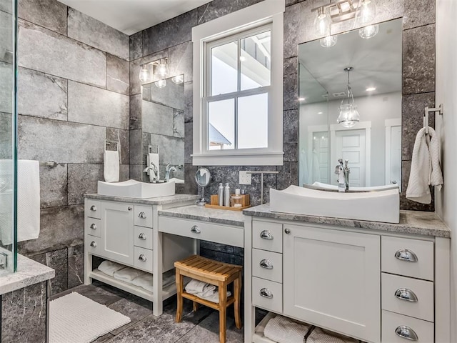 bathroom featuring vanity and tile walls