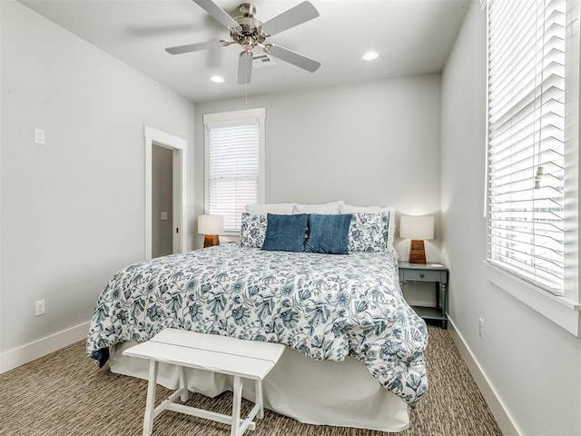 bedroom with carpet, ceiling fan, and multiple windows