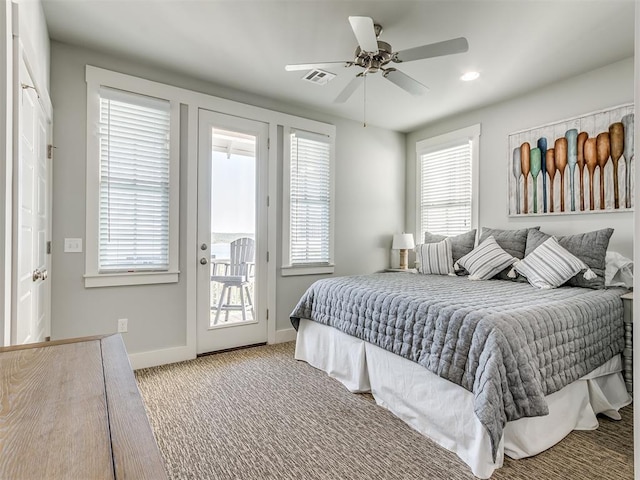 carpeted bedroom with access to outside, multiple windows, and ceiling fan