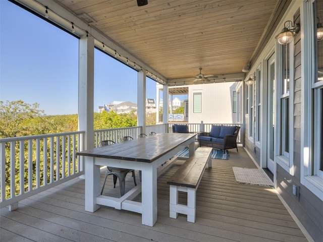 sunroom with ceiling fan and wood ceiling