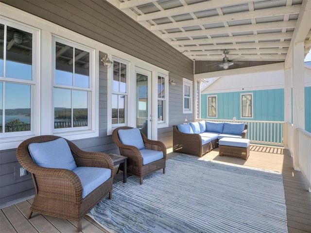 wooden terrace featuring an outdoor living space and ceiling fan