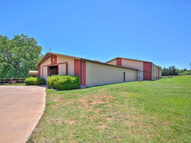 view of home's exterior with a yard and an outdoor structure