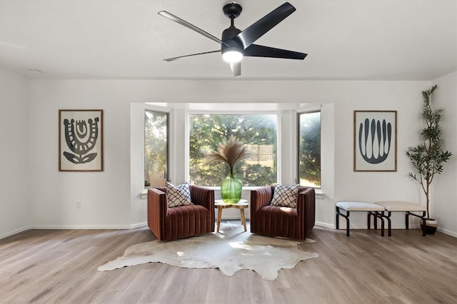 living area featuring ceiling fan and hardwood / wood-style flooring