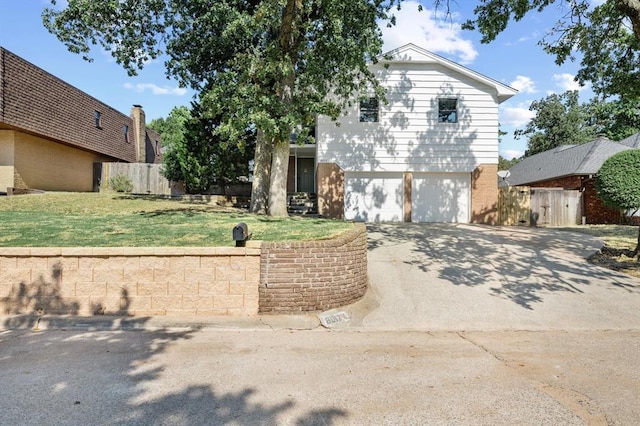 view of front property featuring a front yard and a garage