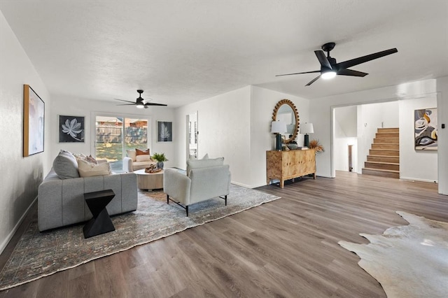 living room with ceiling fan and wood-type flooring